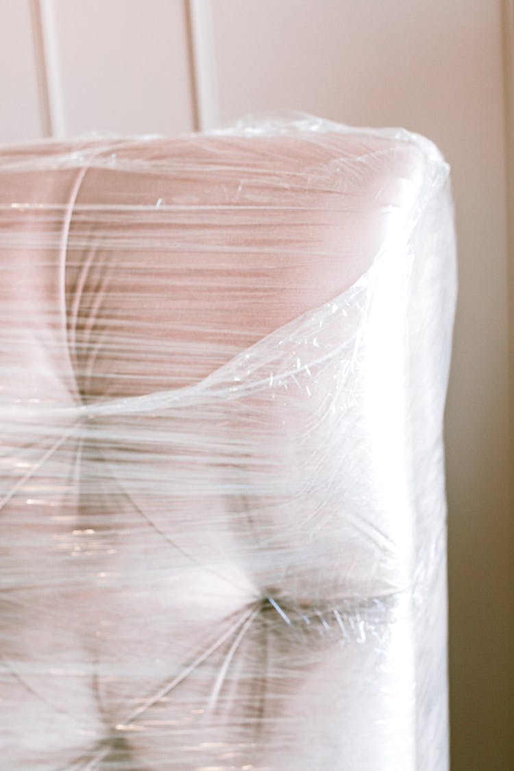 Close-Up Photo Of Couch Wrapped With Plastic