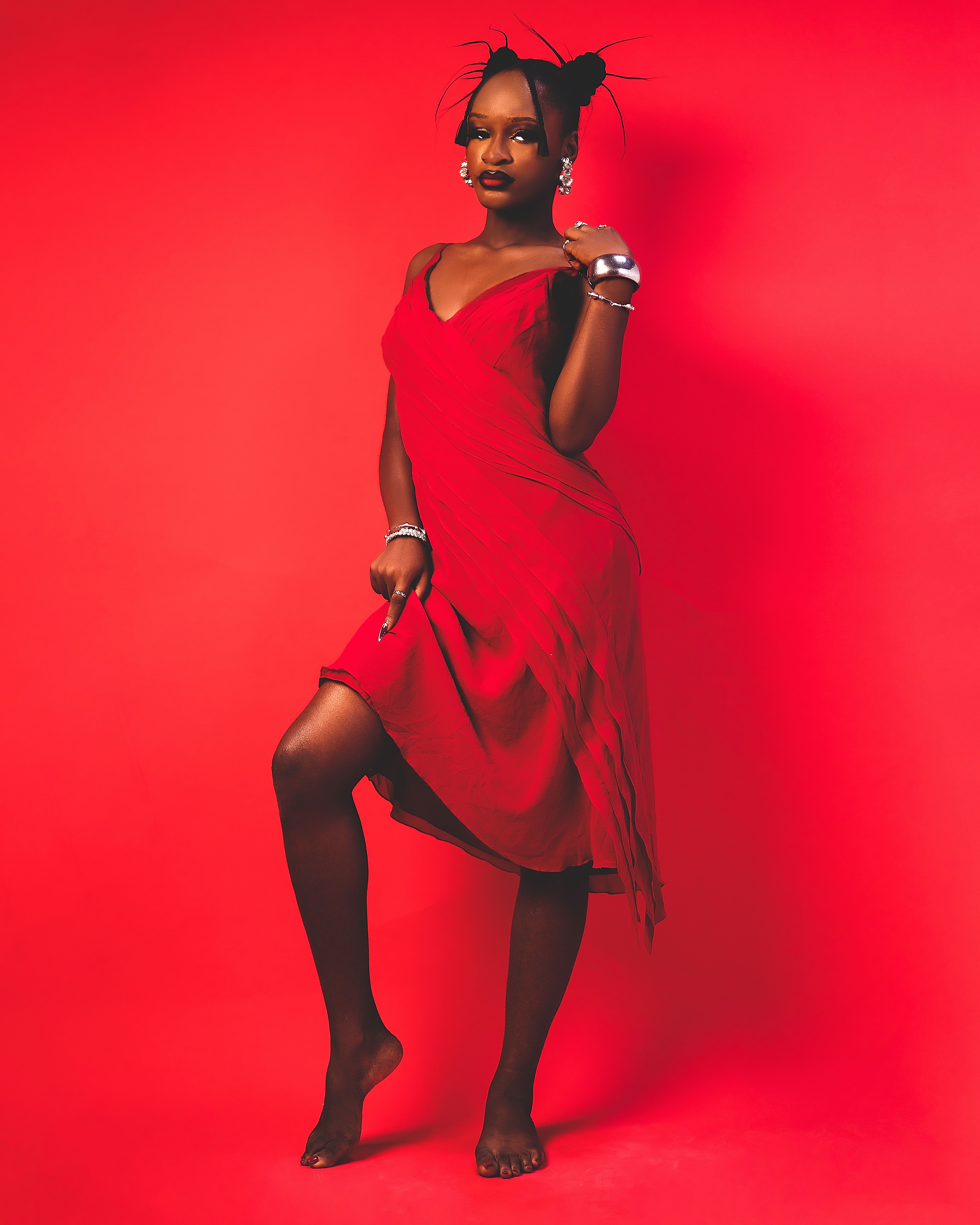 Elegant Woman in Red Dress on Red Background · Free Stock Photo