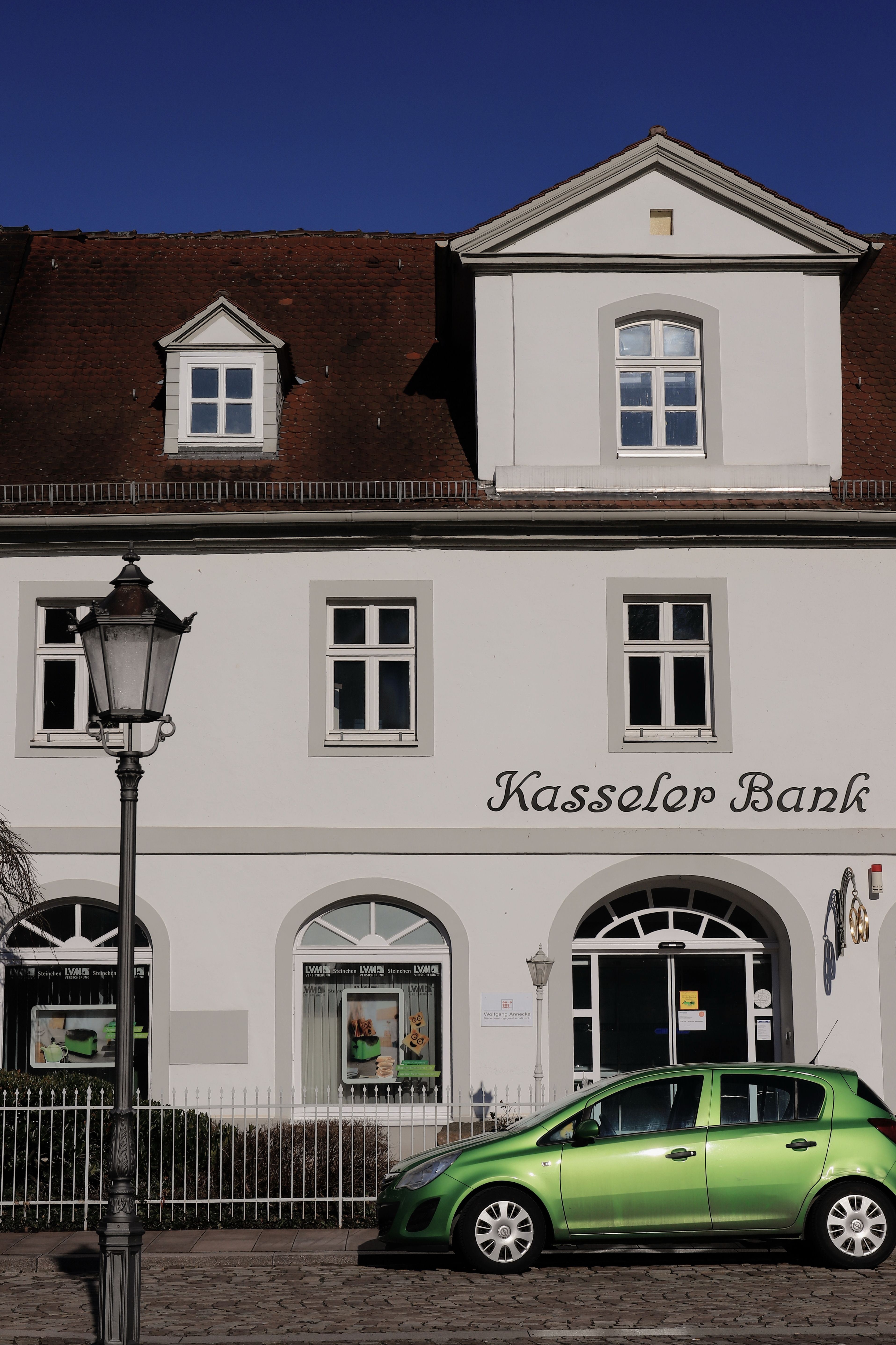 Captivating view of the Kasseler Bank building under a clear blue sky in Bad Karlshafen, Germany.