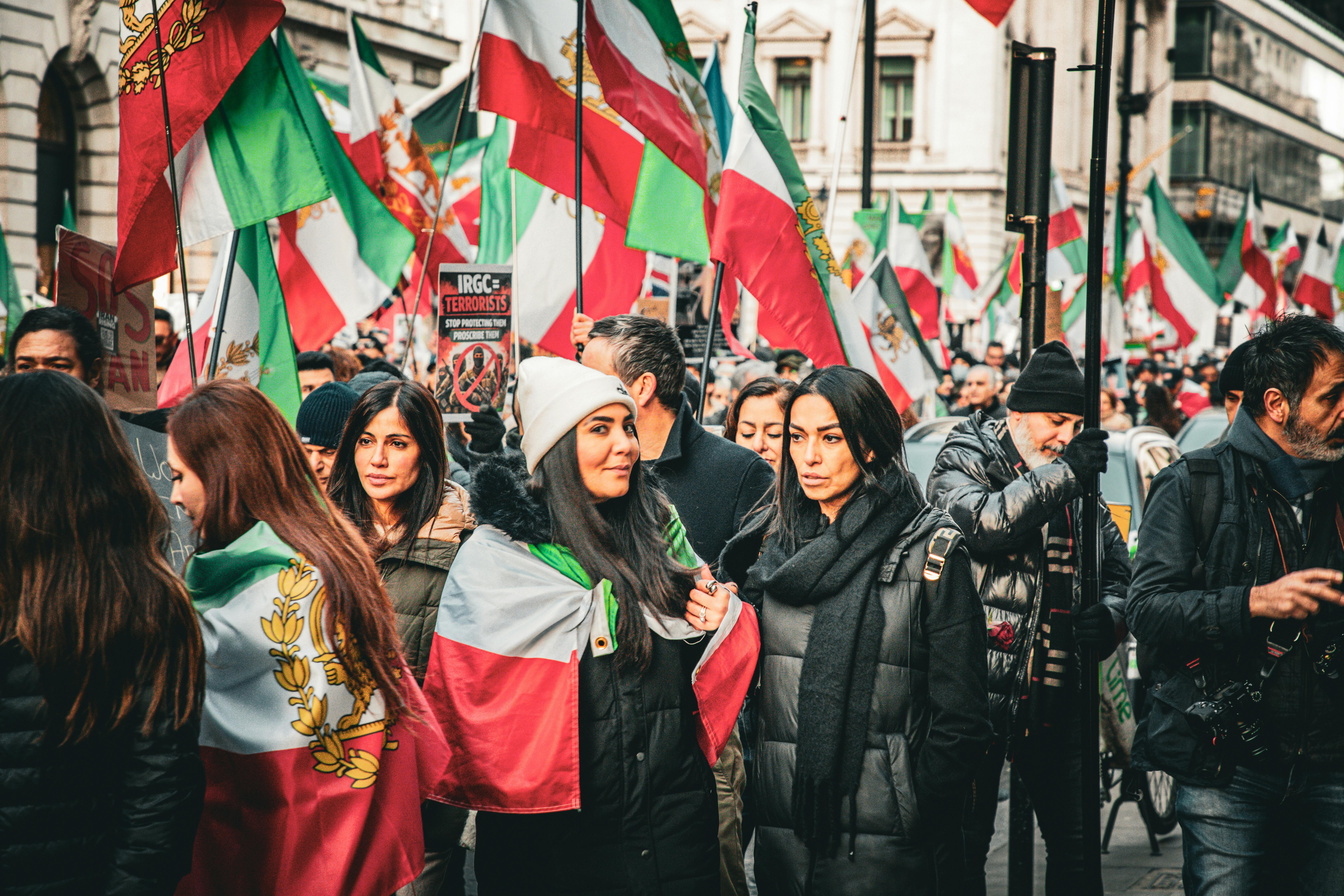 A vibrant street protest in London advocating for Iranian political change.