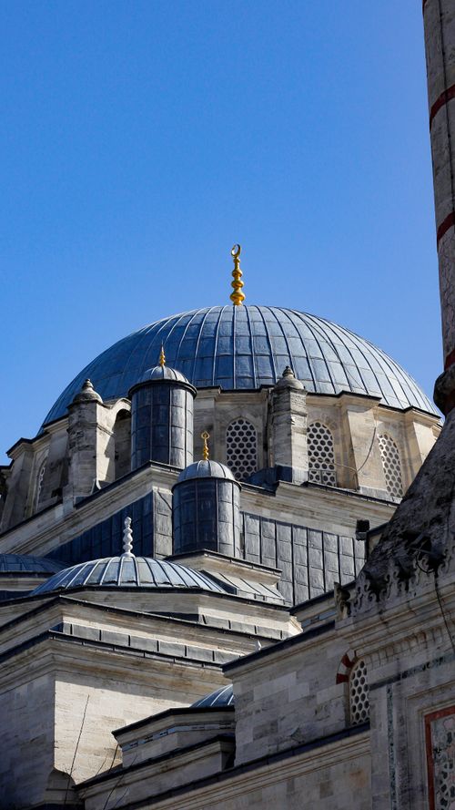 Free Close-up view of an Ottoman-style mosque dome, showcasing intricate Islamic architecture under a clear blue sky. Stock Photo