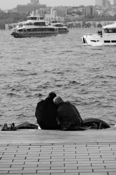 A couple enjoys a peaceful moment by the Bosphorus in Istanbul.