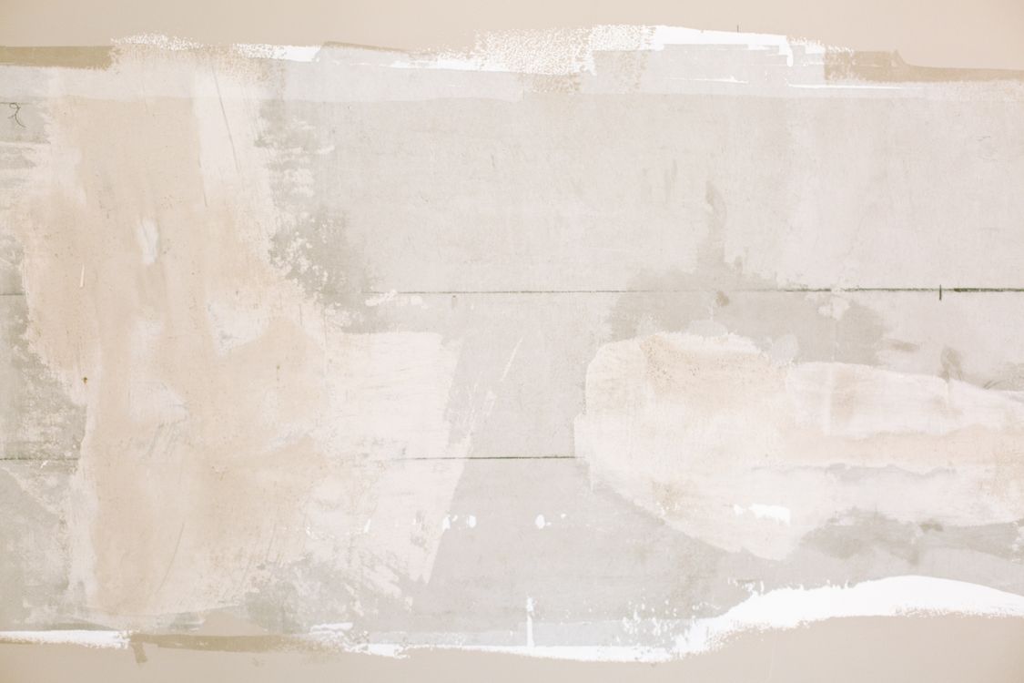 Unfinished wall with plaster and paint texture during interior repairs
