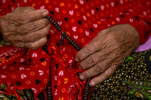 Free Close-up of elderly hands holding prayer beads, highlighting texture and cultural fabric. Stock Photo