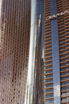 High-rise buildings in Dubai showcasing modern architecture and urban reflections.