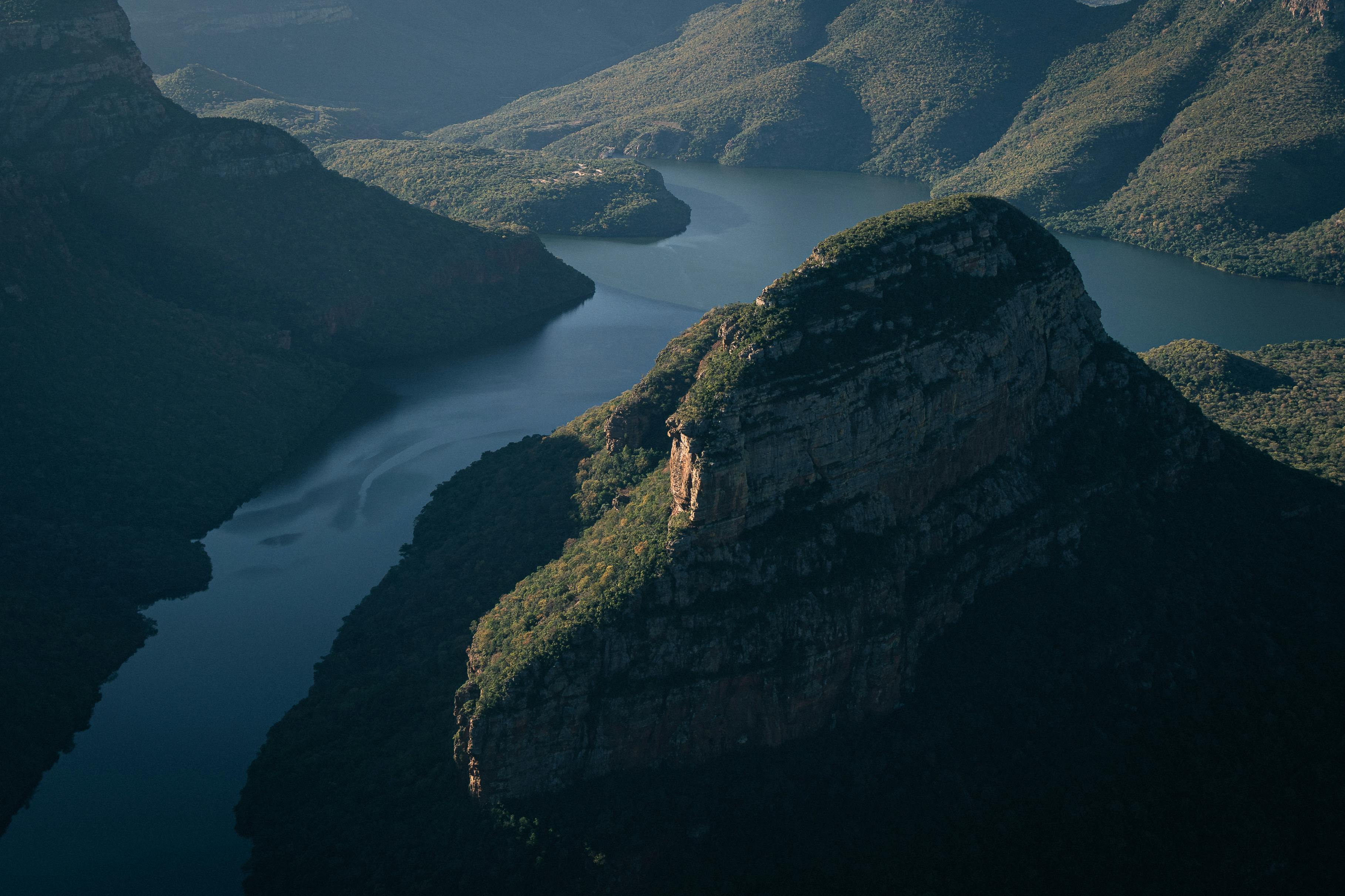 Stunning aerial view of Blyde River Canyon in South Africa, showcasing rugged cliffs and winding river.