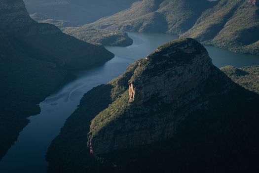 Stunning aerial view of Blyde River Canyon in South Africa, showcasing rugged cliffs and winding river.