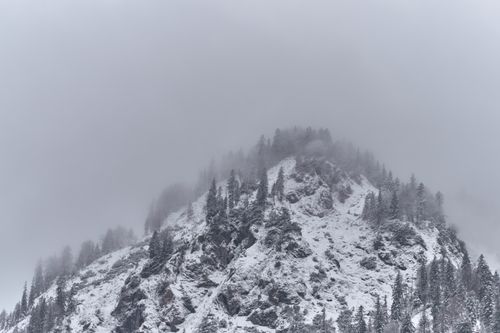 Free Captivating view of a snow-covered mountain peak shrouded in mist in Kreuth, Bavaria. Stock Photo