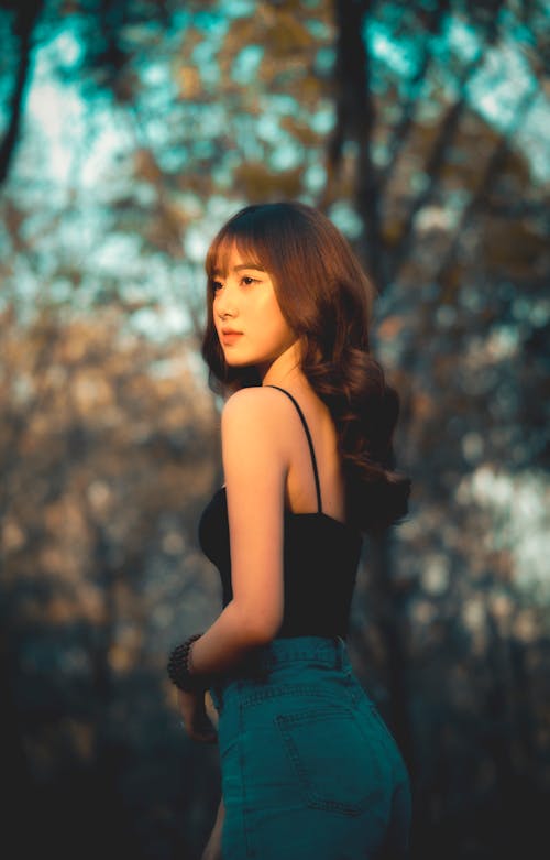 Free Woman in Black Spaghetti Strap Top and Blue Denim Skirt Stock Photo