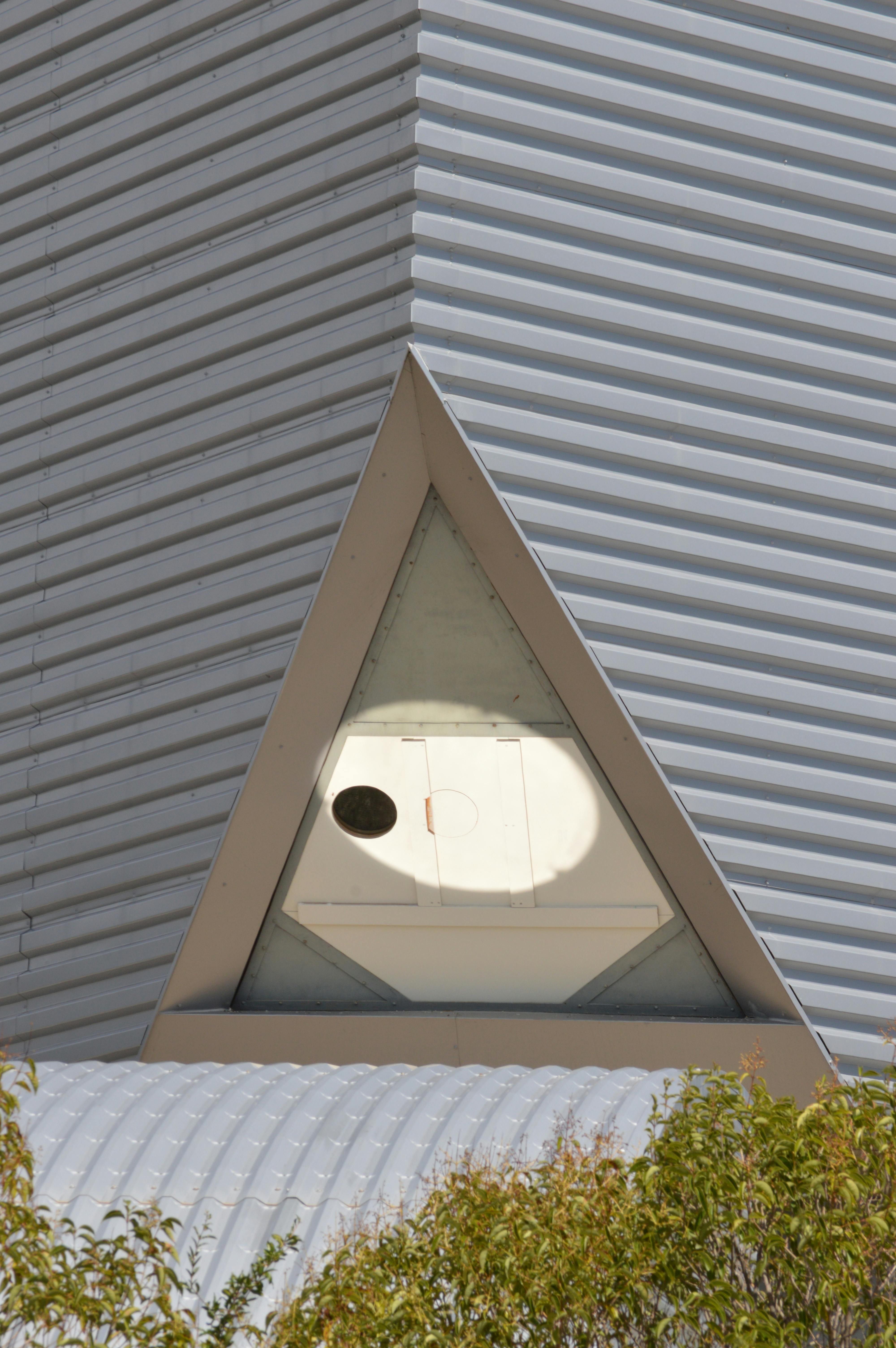 Free Close-up of a triangle window on a modern building facade in Provence-Alpes-Côte d'Azur, France. Stock Photo