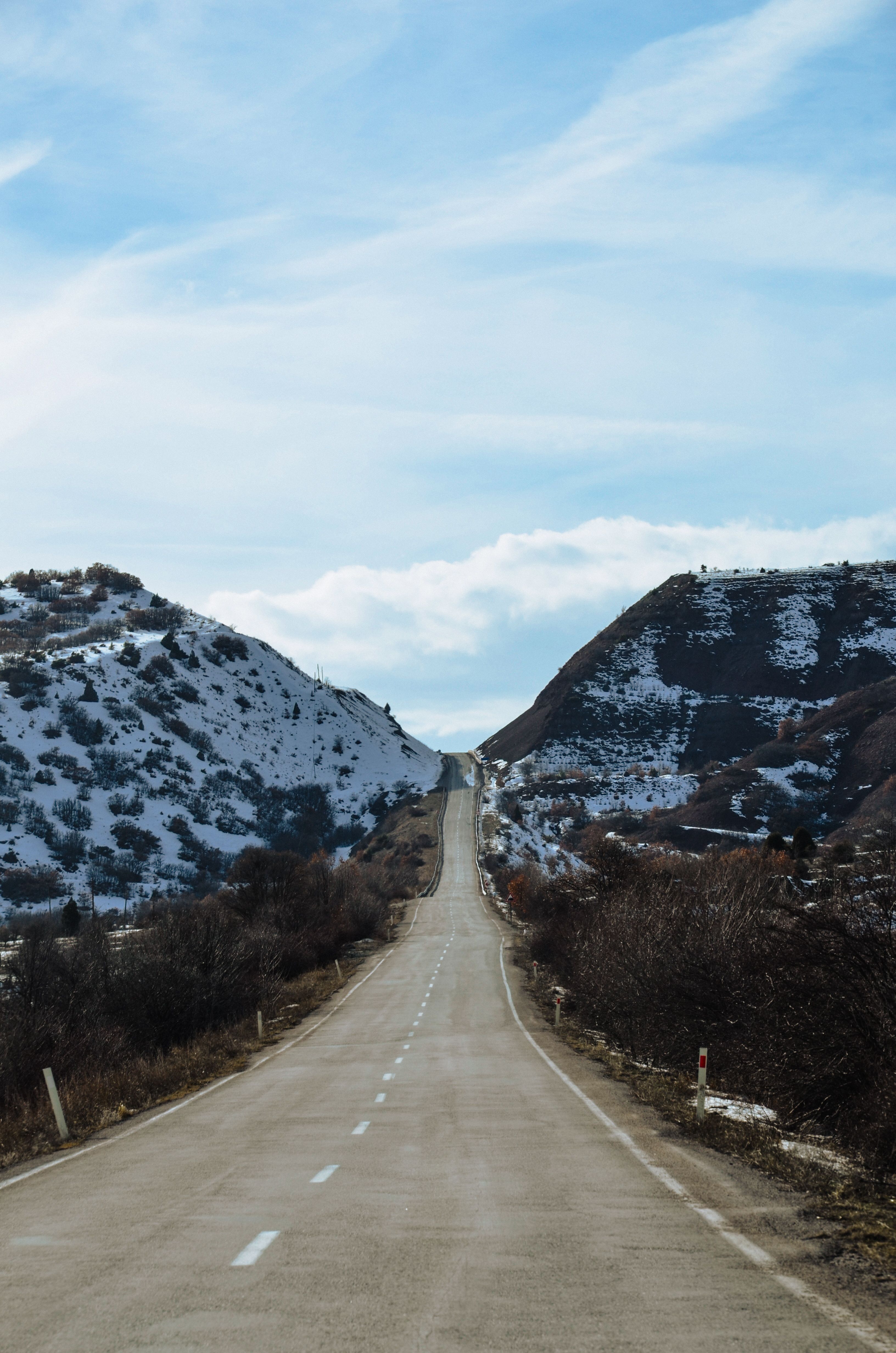 Scenic Winter Road Through Snowy Mountain Landscape · Free Stock Photo