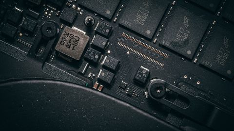 Detailed macro shot of electronic circuit board showing microchips and components.