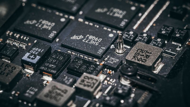 Detailed close-up of electronic microchips on a circuit board, showcasing technology and engineering intricacies.