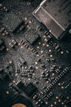 Macro shot of a dusty computer circuit board with intricate components and connectors.
