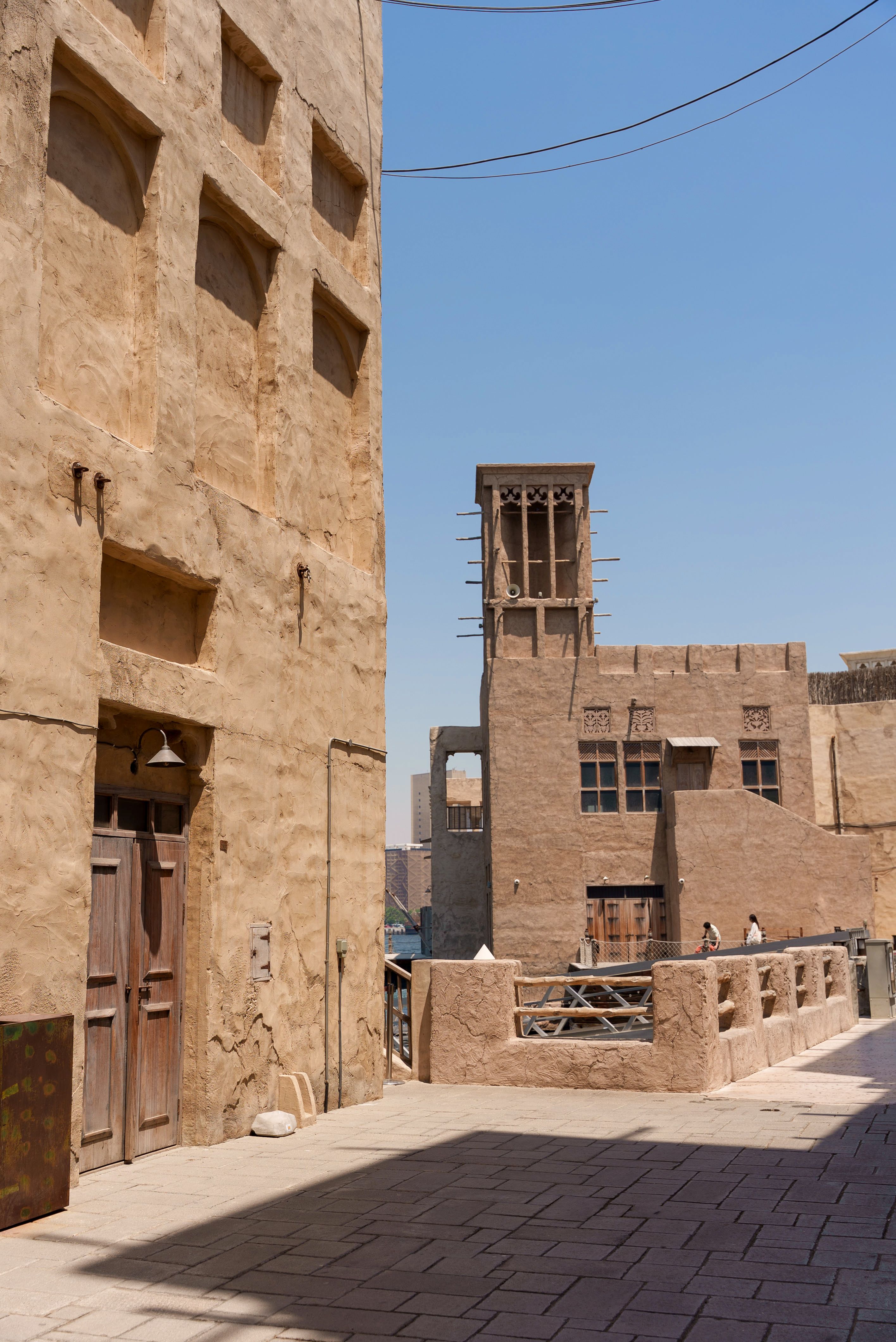 Explore the historic Al Fahidi district in Dubai, showcasing its traditional wind towers and sandstone architecture.