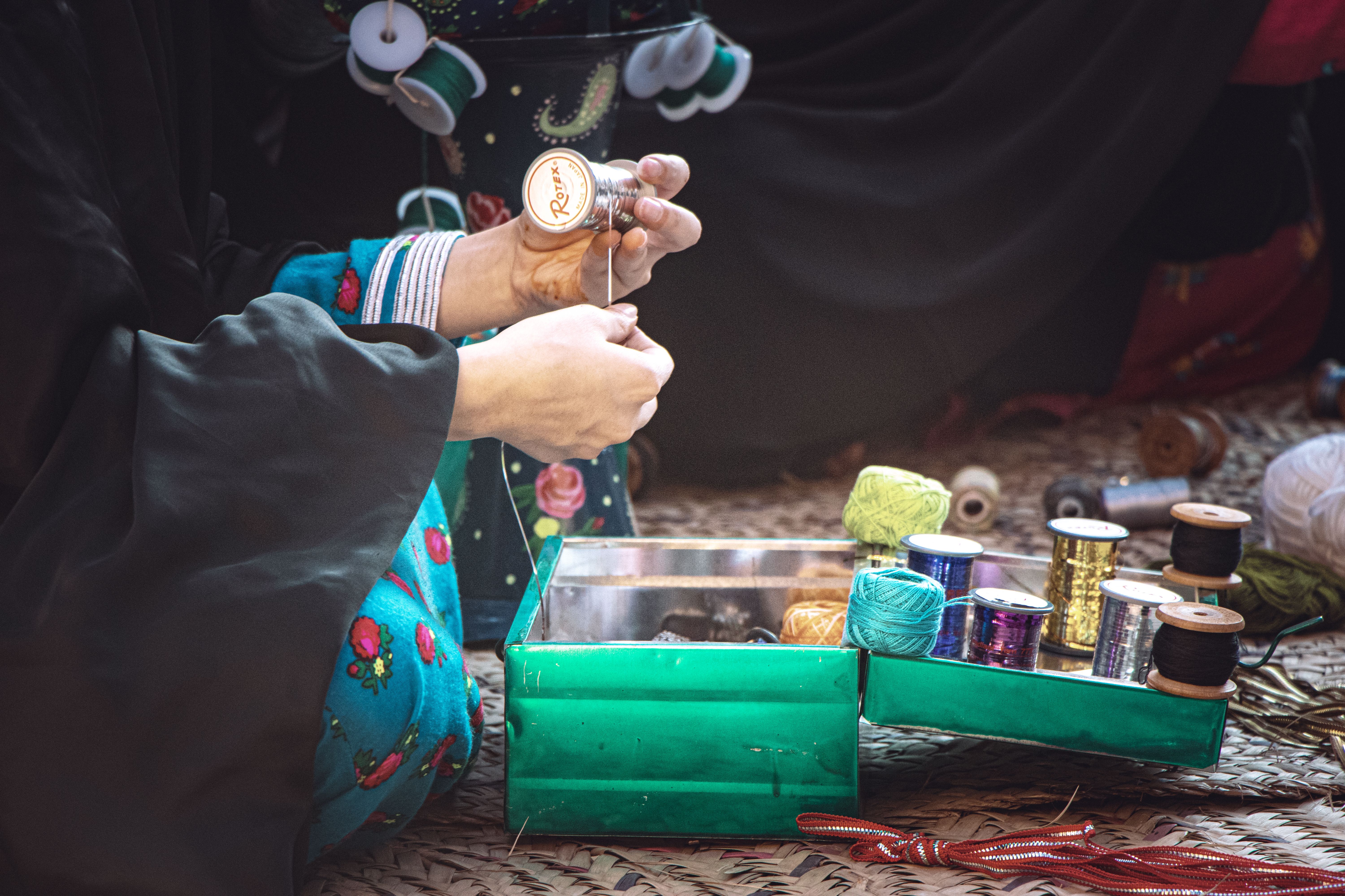 Woman crafting with vibrant thread collection · Free Stock Photo