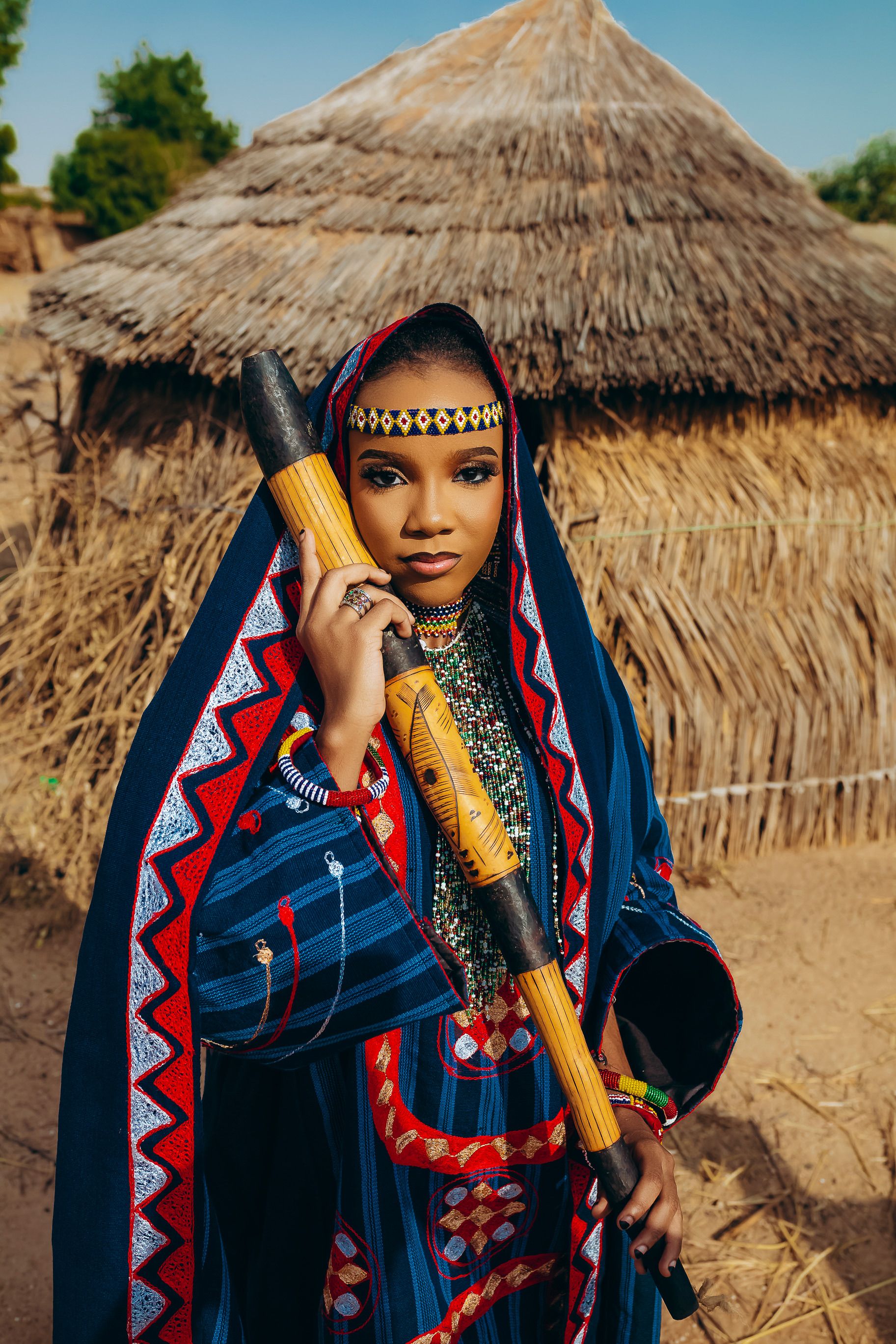 Woman in Traditional African Attire Holding Instrument · Free Stock Photo