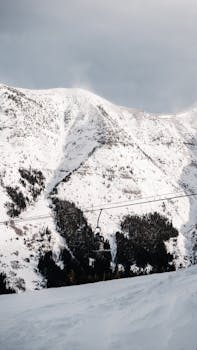 A stunning snowy mountain landscape with a ski lift, captured in Alberta, Canada.