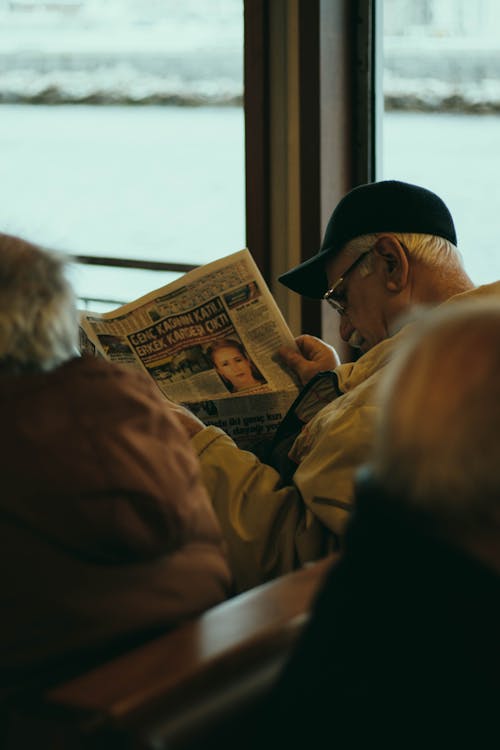 Man in Brown Jacket Sitting Beside Woman in Brown Jacket