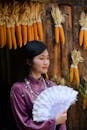 Woman in Traditional Outfit with Corn Decorations