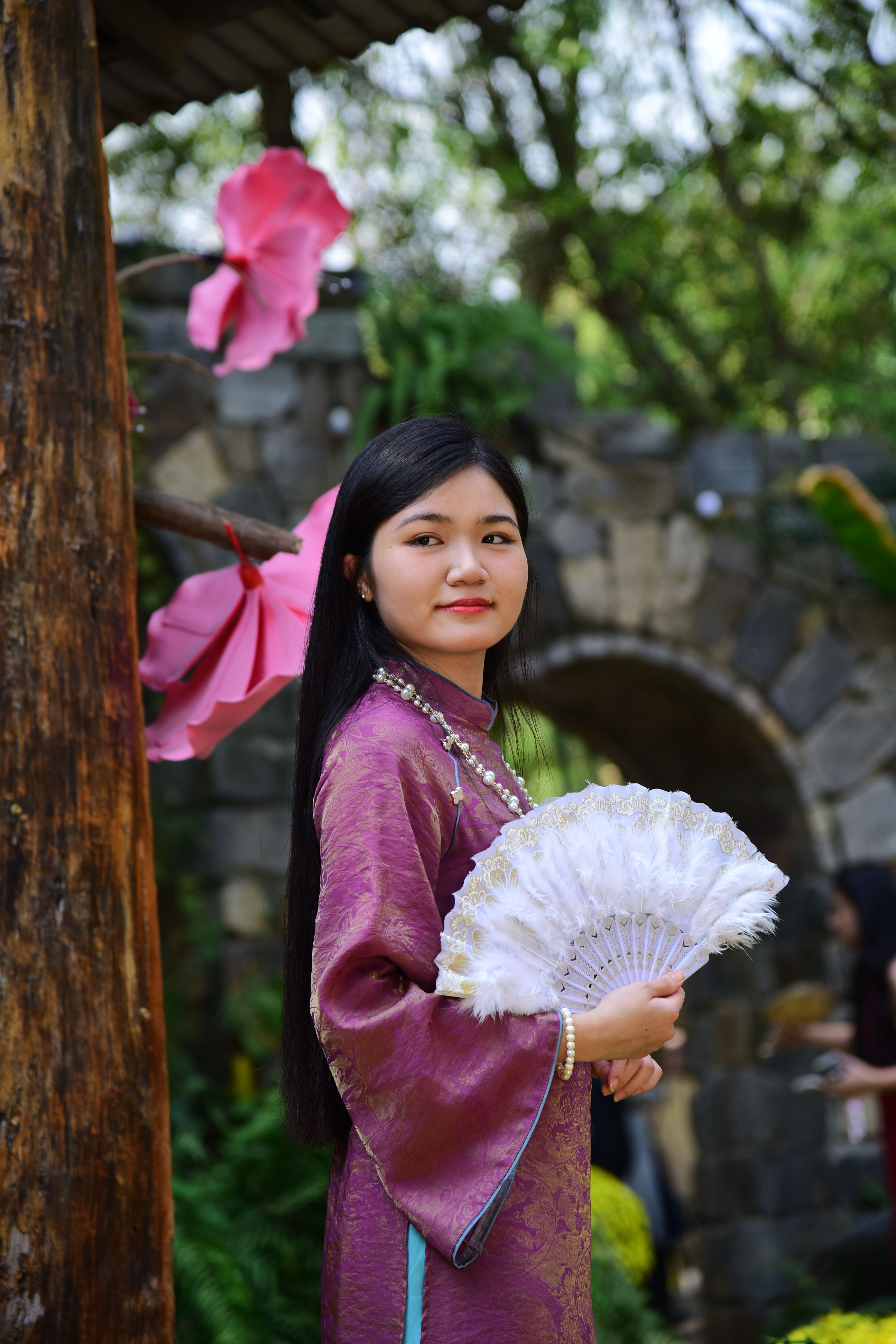Young Woman in Traditional Attire with Fan Outdoors · Free Stock Photo