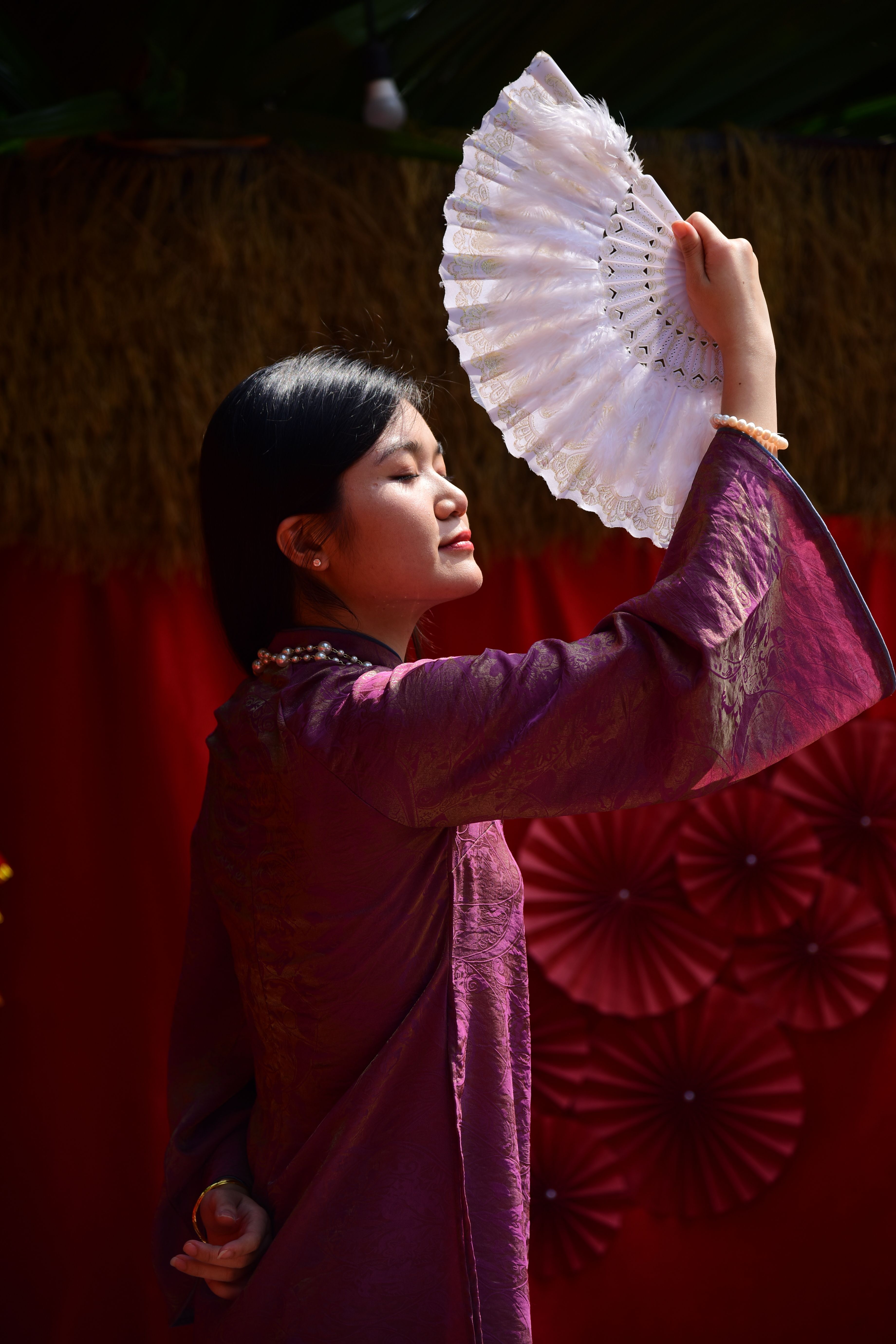 Elegant Woman in Traditional Dress with Fan · Free Stock Photo