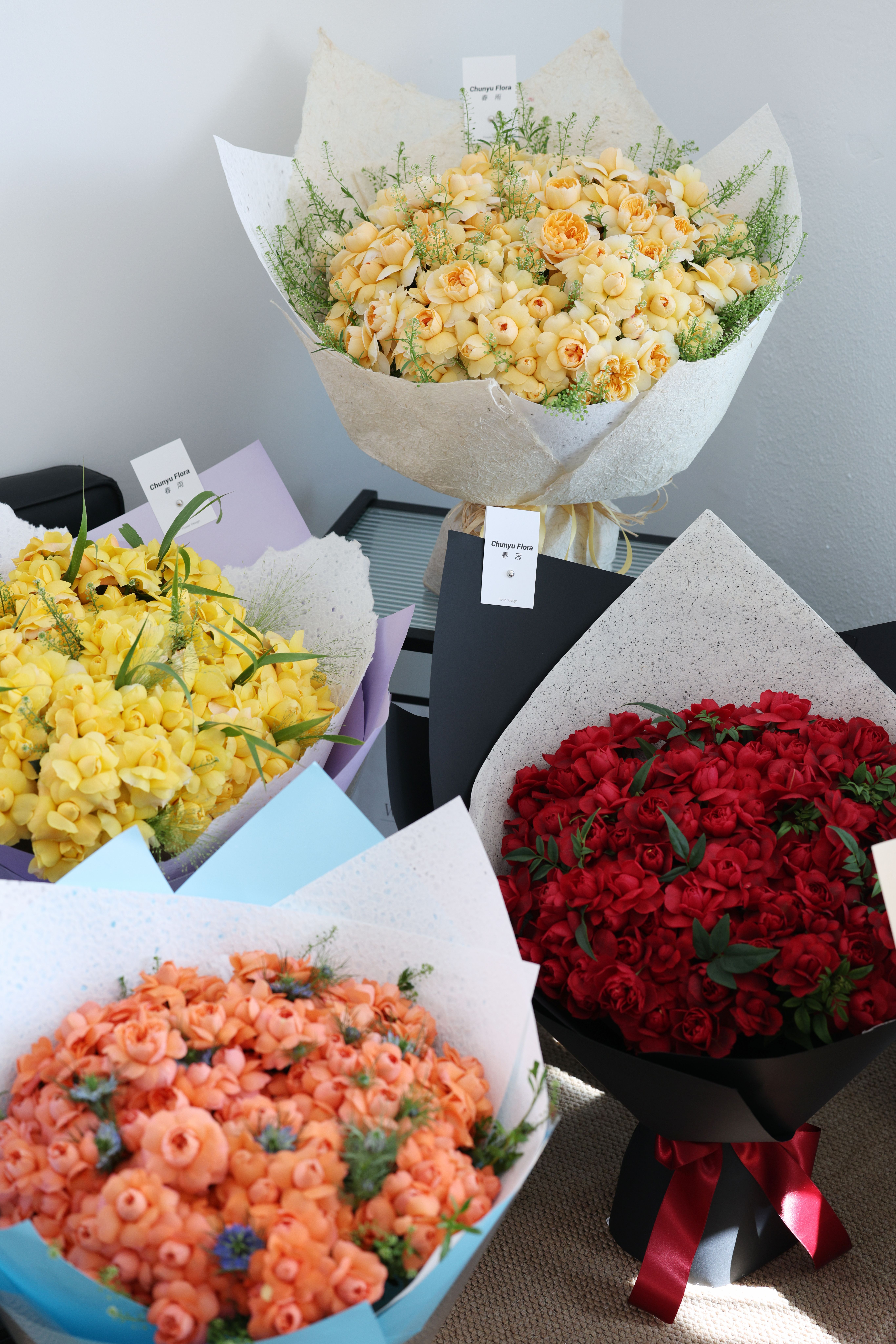 An assortment of wrapped bouquets arranged in a sunlit room