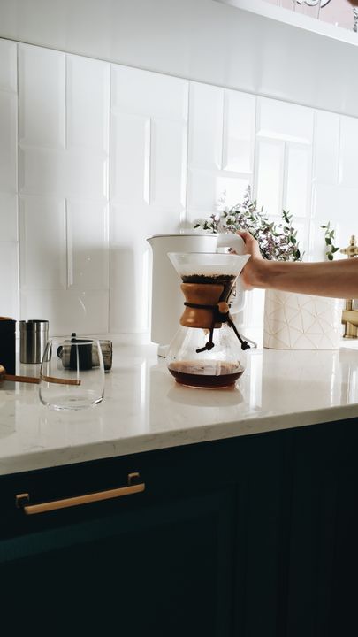 Café-Quality Coffee at Home: The Indian Guide to Espresso, Filter, and Cold Brew 3 A glass jar of cold brew coffee steeping on a kitchen counter with ice cubes and a glass nearby