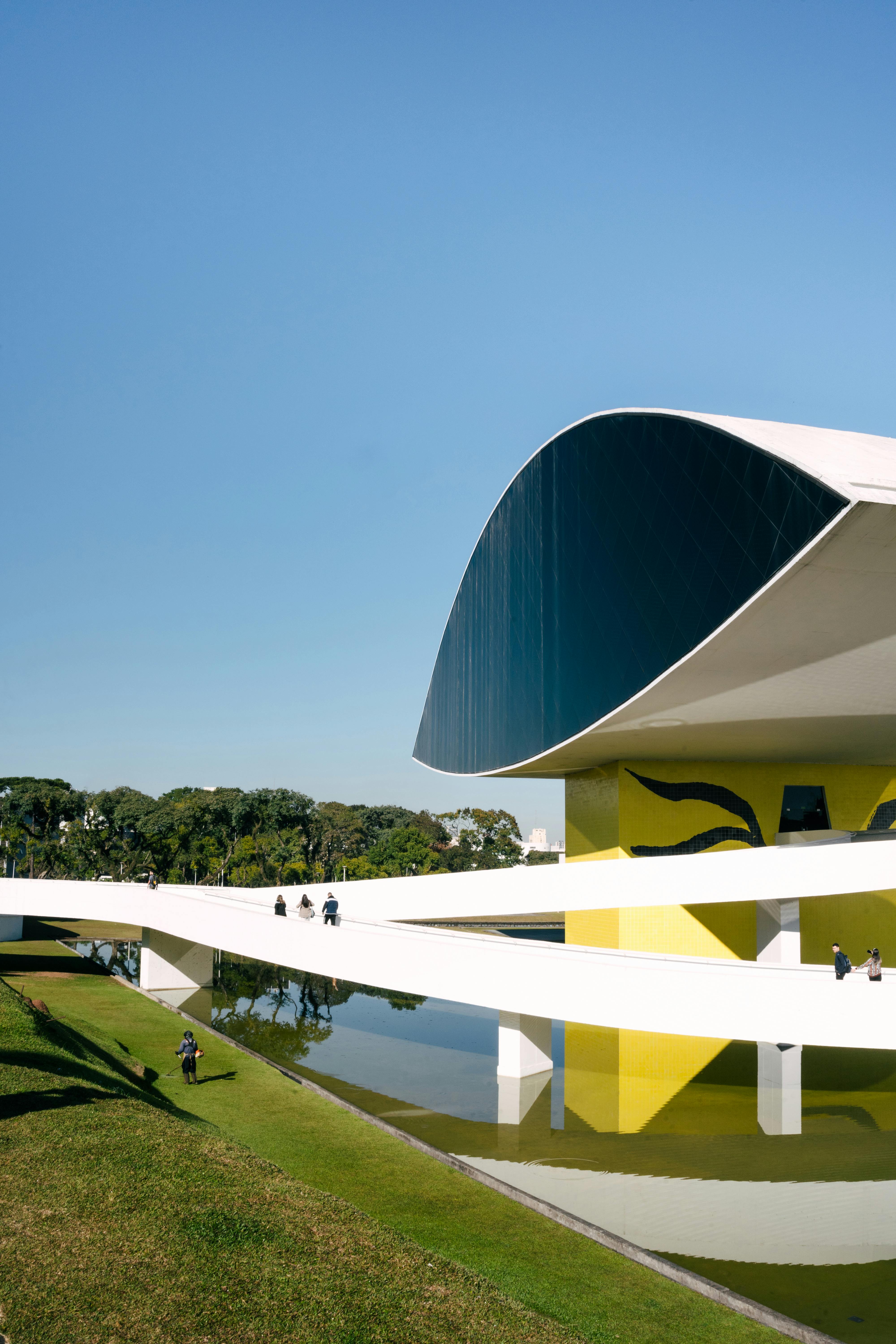 Oscar Niemeyer Museum's futuristic architecture in Curitiba, Brazil, under a clear blue sky.