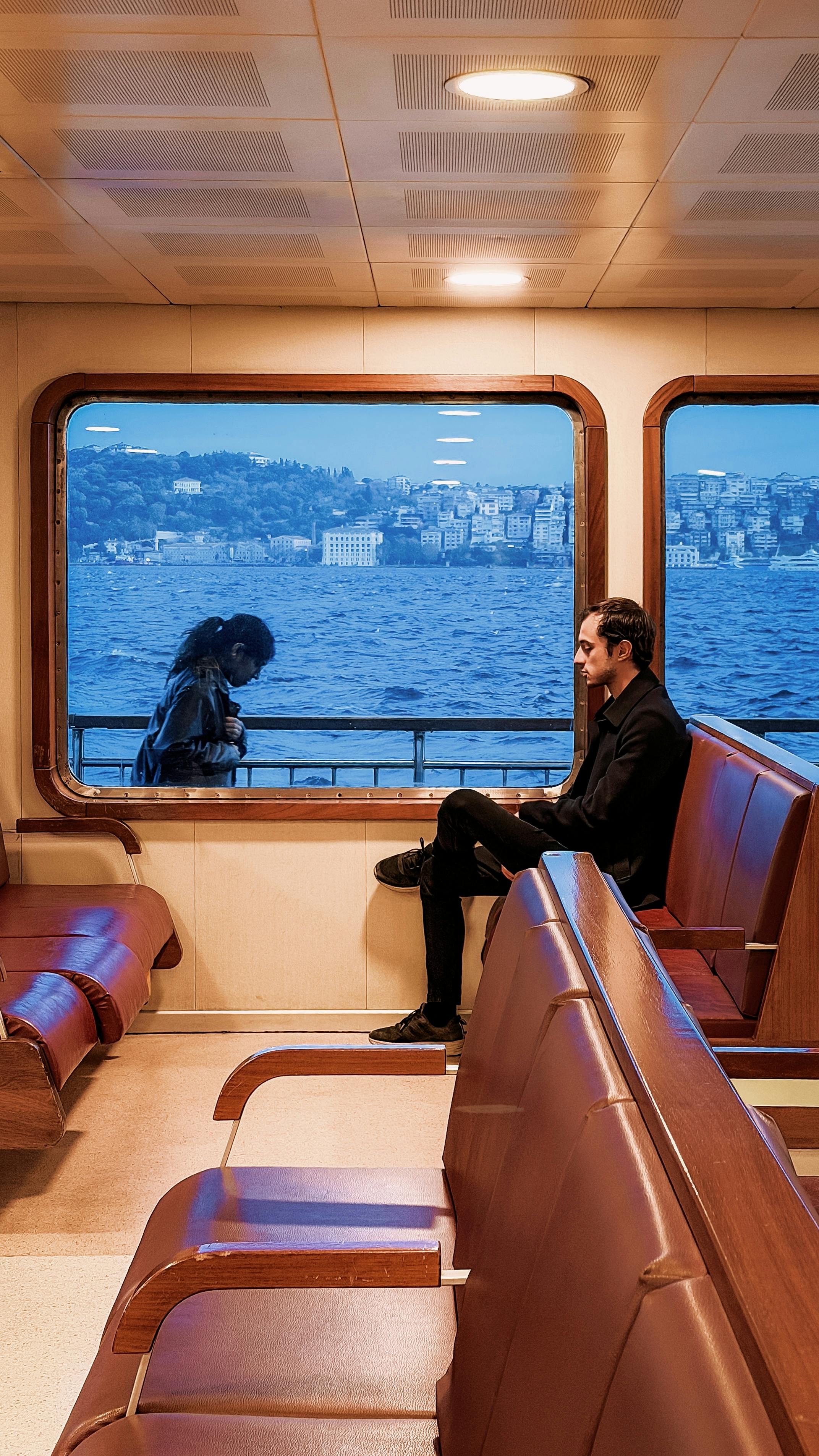 A serene ferry ride on the Bosphorus in Istanbul with passengers enjoying the view.