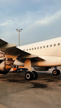 Close-up of a passenger airplane on the tarmac at Istanbul Airport during sunset.