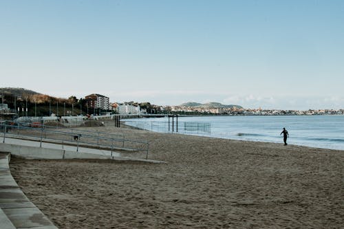 Person Walking on Beach