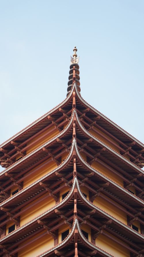 Free Close-up view of a traditional Asian pagoda tower with intricate architectural details under a clear sky. Stock Photo