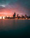 City Skyline Across Body of Water during Night Time