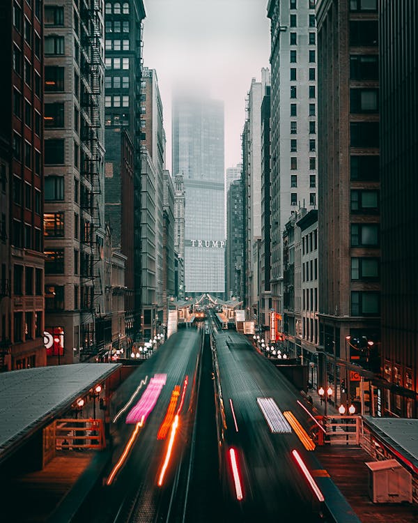 Free Cars on Road Between High Rise Buildings Stock Photo