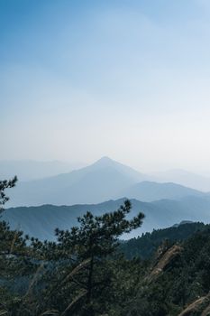 Breathtaking view of undulating mountains under a clear morning sky, offering tranquility and peace.