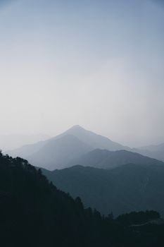 A calming view of misty mountain ranges at dawn, showcasing natural beauty.
