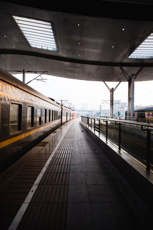 Free A sleek train station interior featuring a modern design and an approaching train. Perfect for travel concepts. Stock Photo
