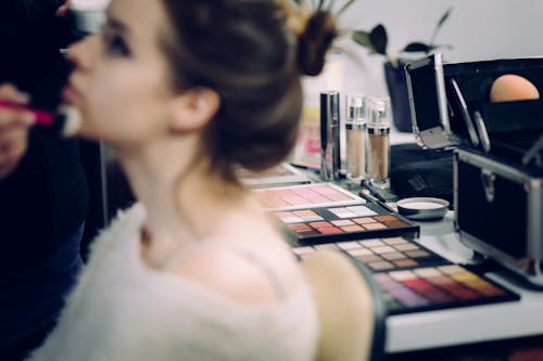 Woman Sitting Doing Makeup