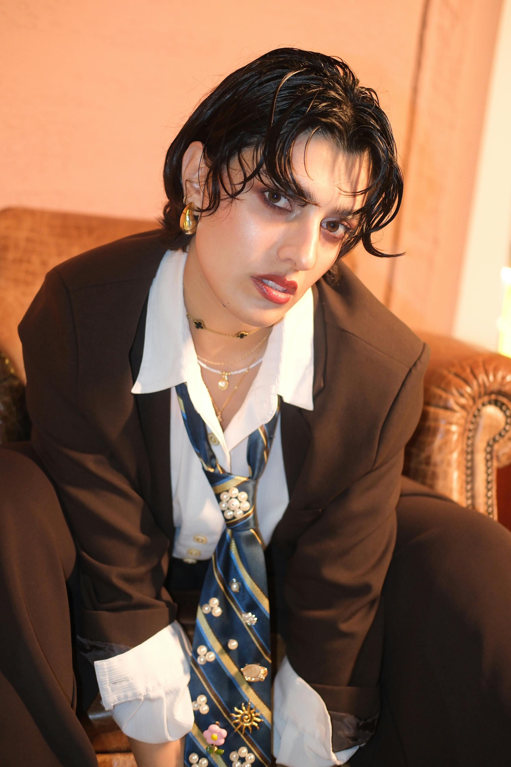 Free A young adult poses confidently in modern business attire, exuding a bold and artistic flair. Stock Photo