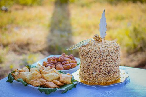 Free Delicious crunchy nut cake and pastries displayed on a table outdoors, perfect for a celebration. Stock Photo