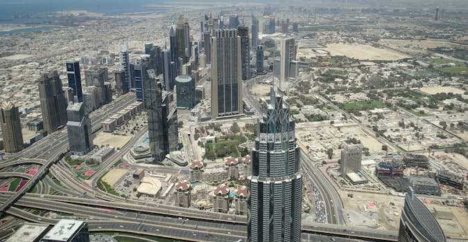 Discover Dubai's modern skyline from above, showcasing its iconic skyscrapers and bustling city life.