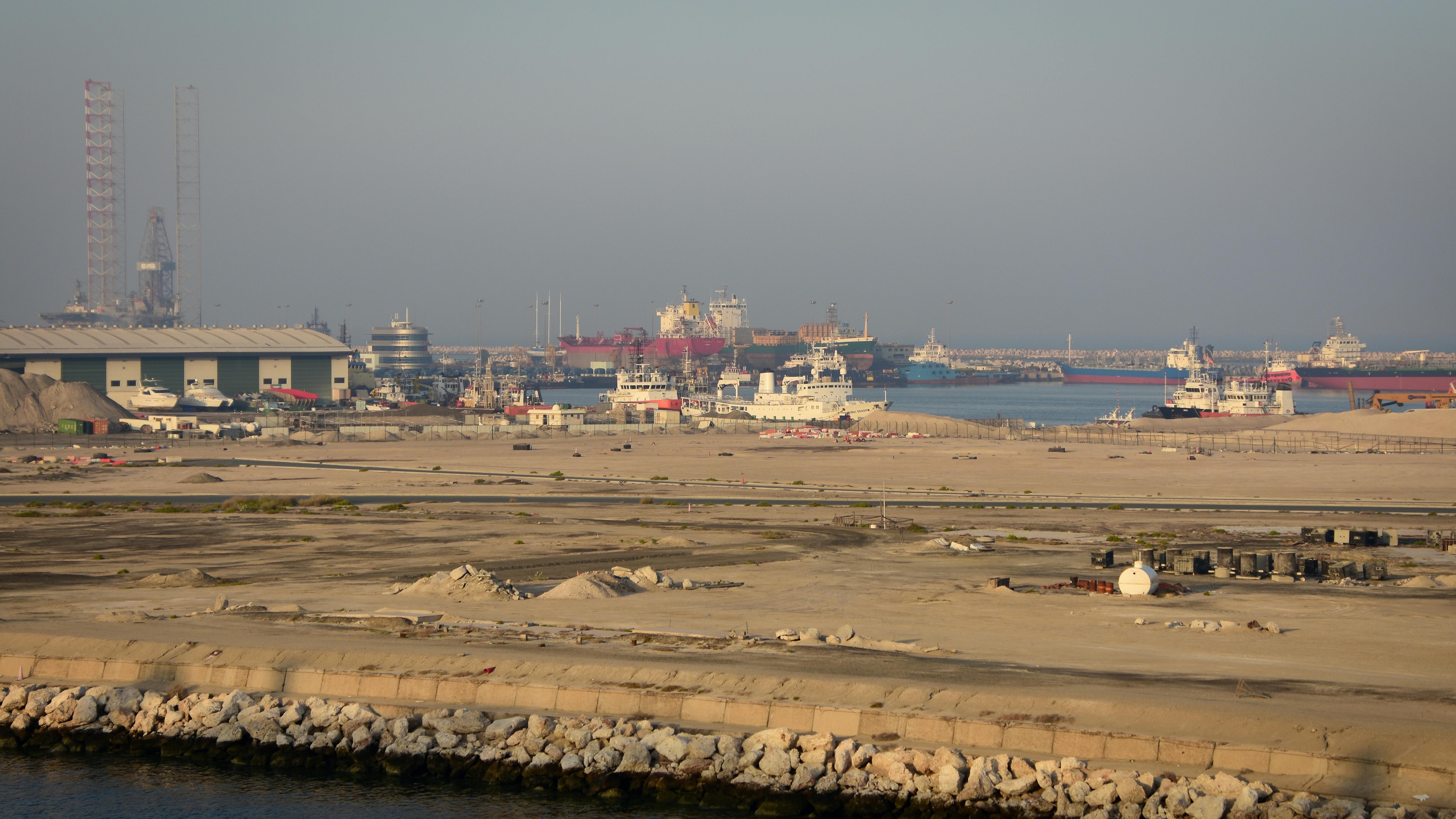 Dubai's iconic skyline and its bustling port of Jebel Ali symbolize its economic might, but this image now represents the interconnected pillars under severe threat from regional instability and trade disruptions.