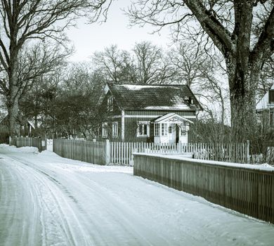Charming wooden house surrounded by snow, evoking a peaceful winter atmosphere.