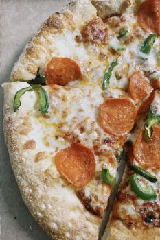 Delicious pepperoni pizza with melted cheese and green peppers, perfect for a savory treat.