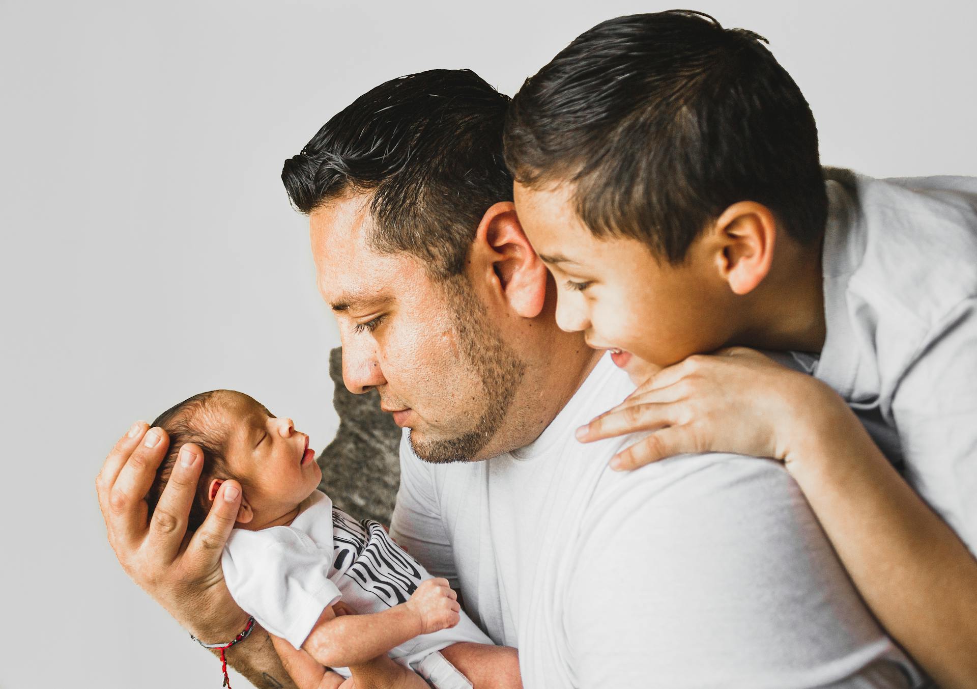 Photo Of Man Carrying Newborn Baby