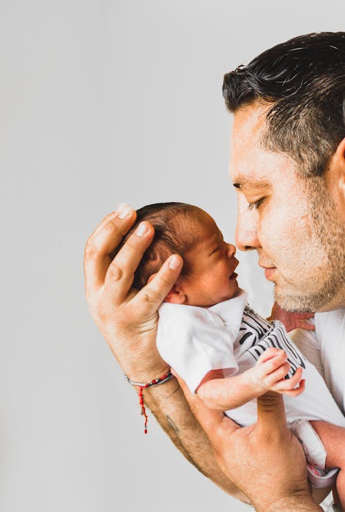 Free Photo Of Man Carrying Newborn Baby Stock Photo