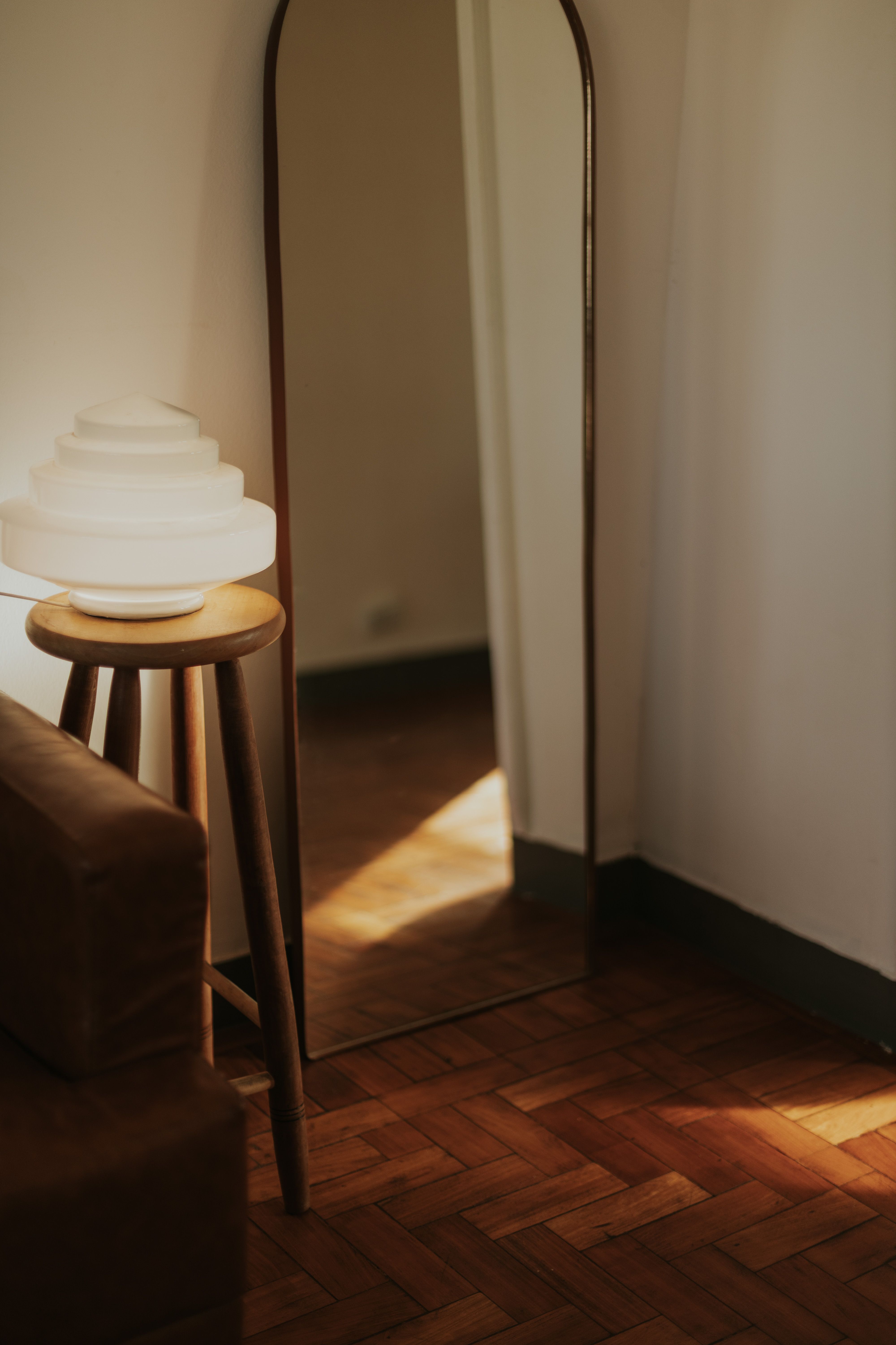 Warm interior view with a stylish lamp and wooden floor.
