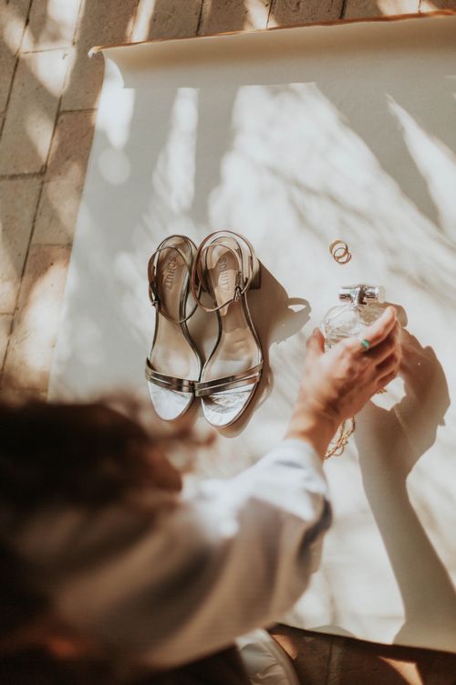 Free Stylish flat lay of silver heels, rings, and a perfume bottle. Perfect for wedding themes. Stock Photo
