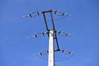 Industrial Power Pole Against Clear Blue Sky